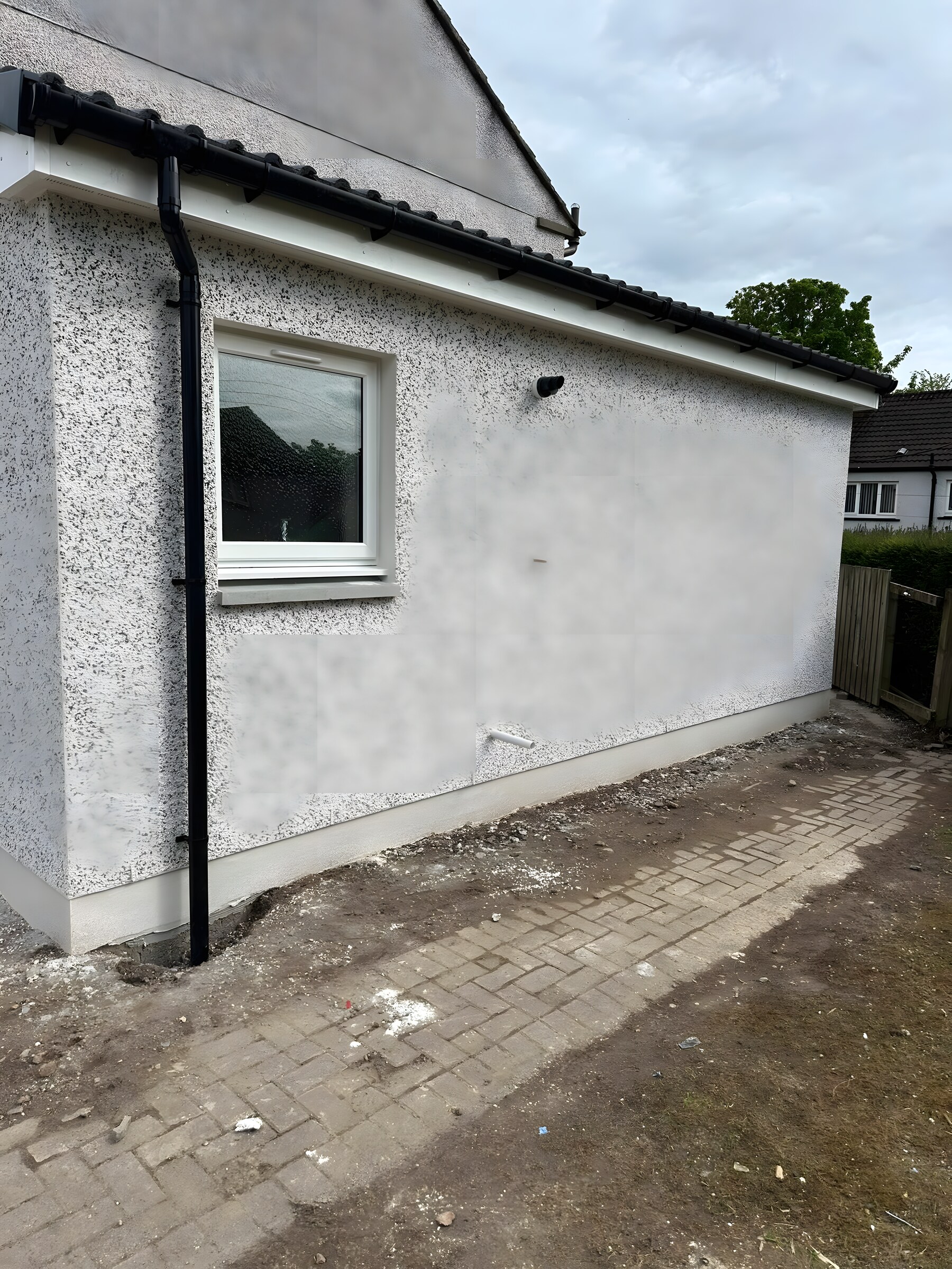 Roughcast on, fascia, gutter and downpipe fitted