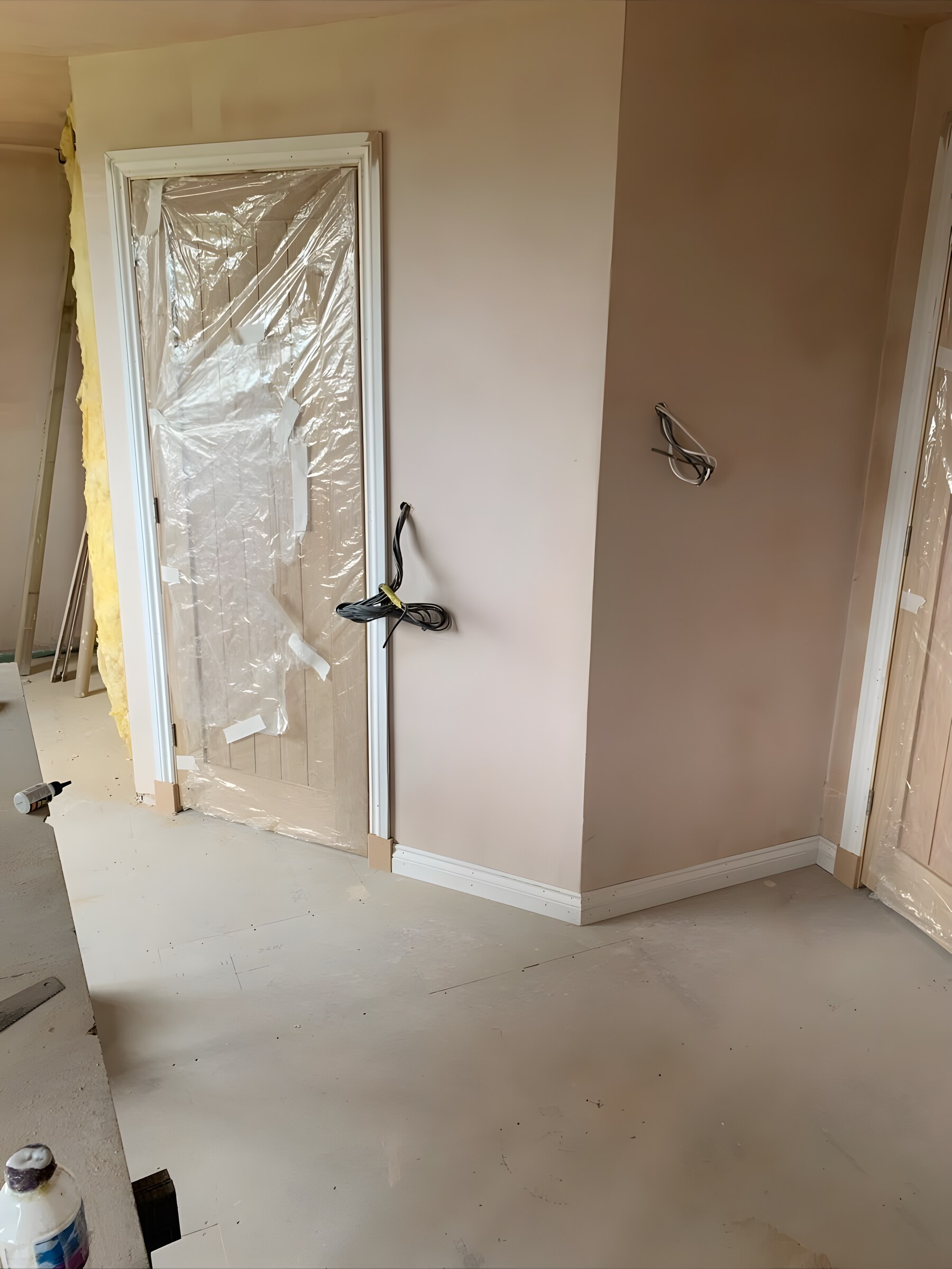 An oak door hung and cased, still in its wrap