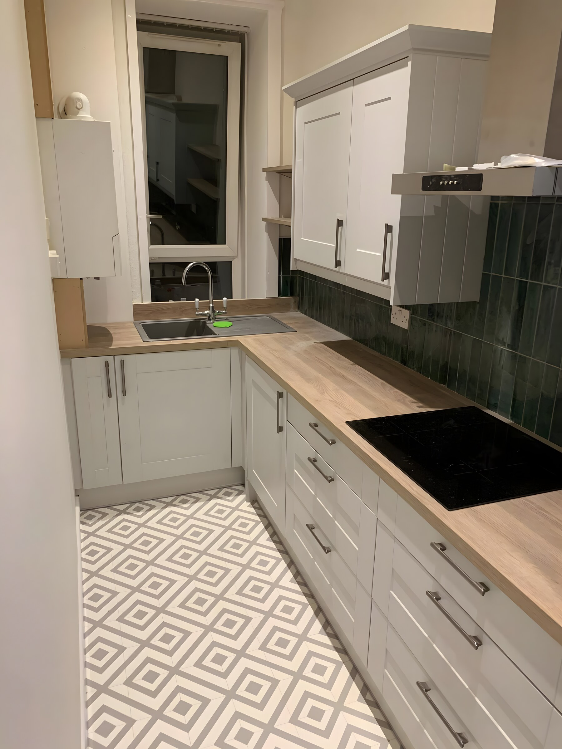 Painted shaker in a galley, with the dark green tile