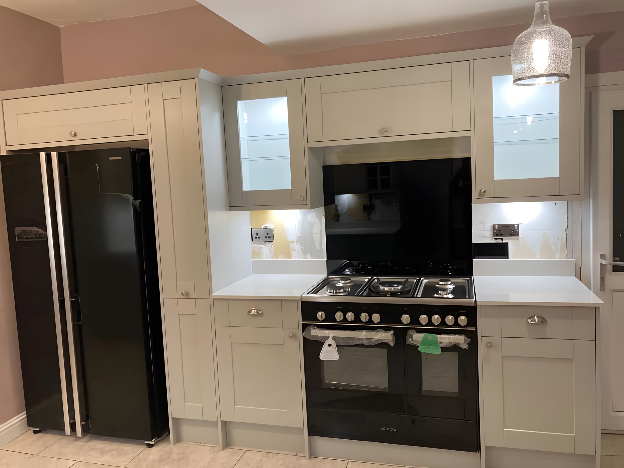 Grey shaker, glazed wall units, black range
