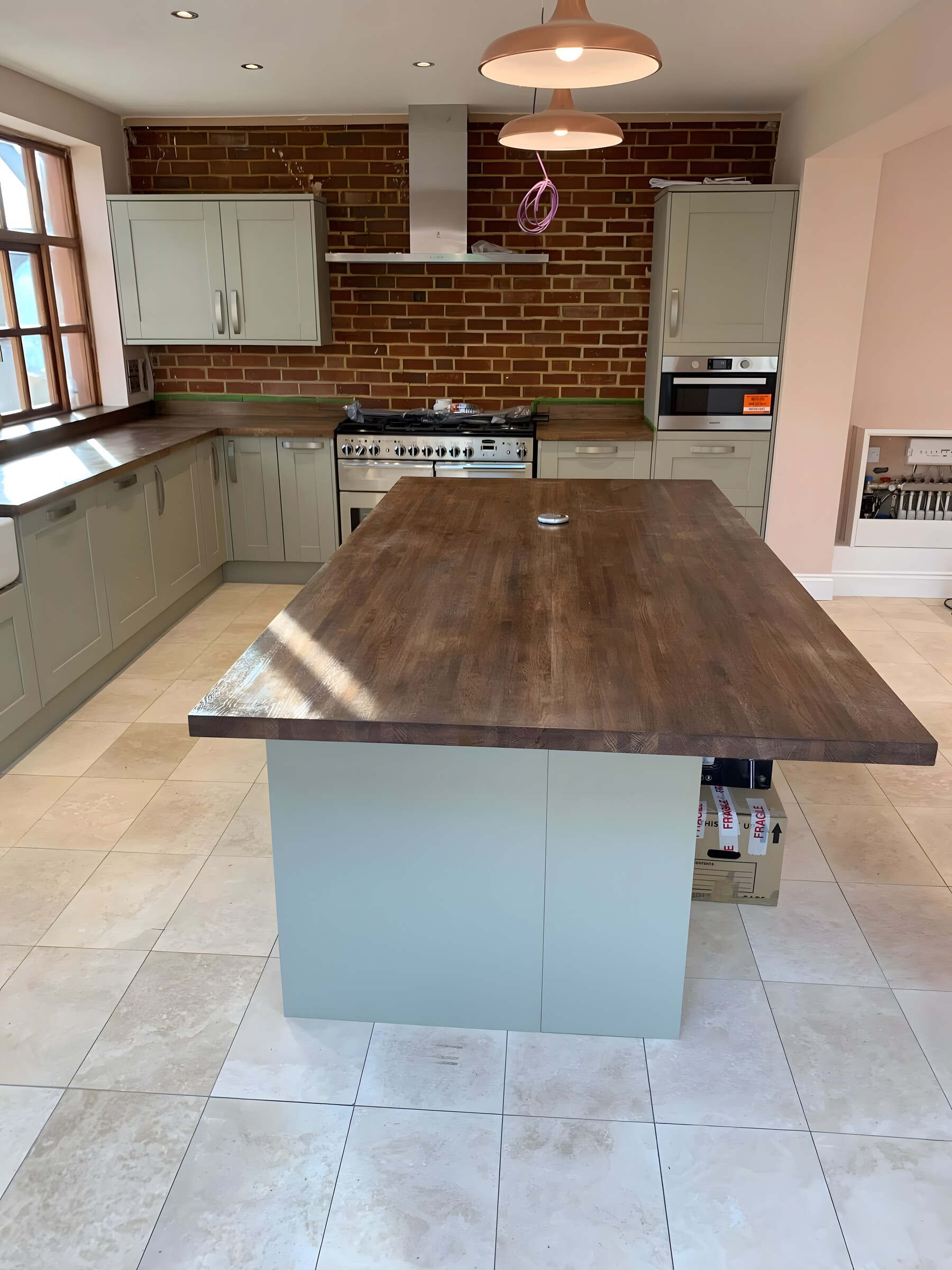 Sage shaker, walnut island, exposed brick — 2025