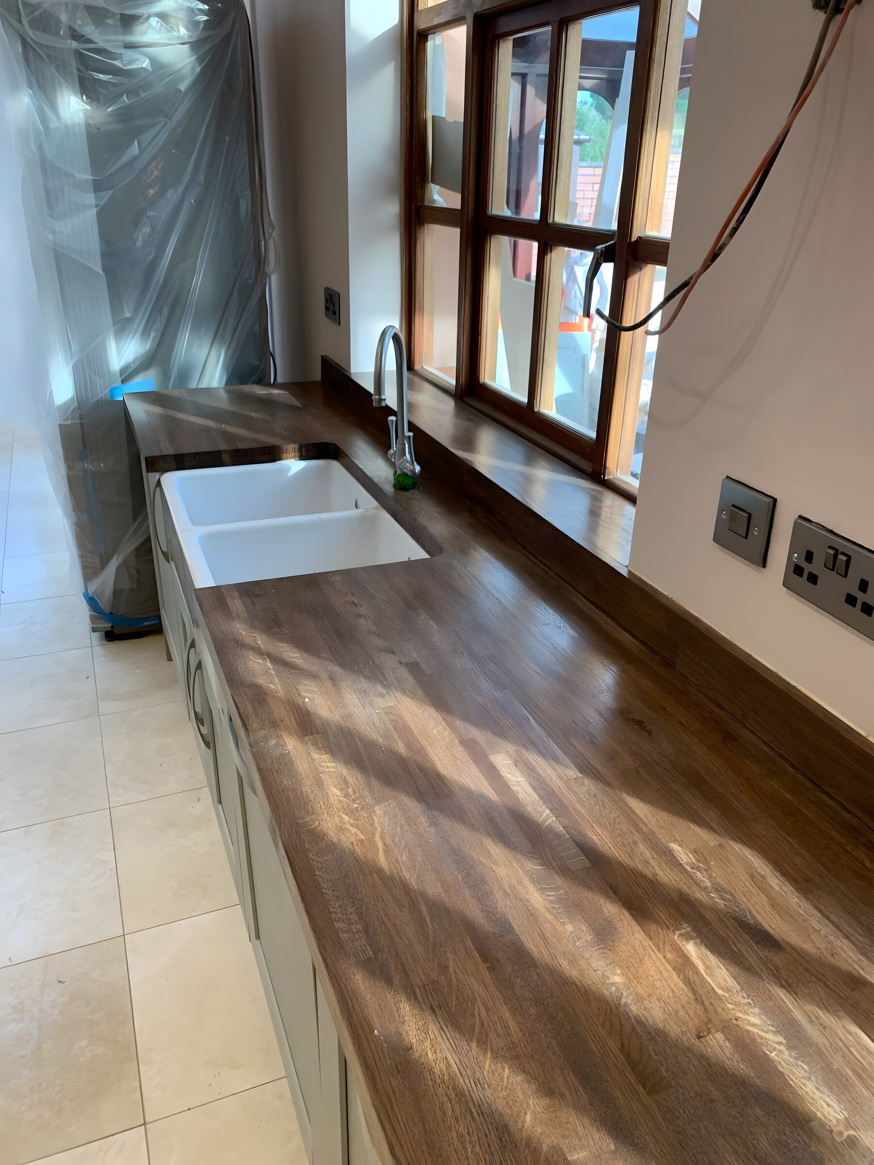 Dark-stained solid oak, running into a belfast sink