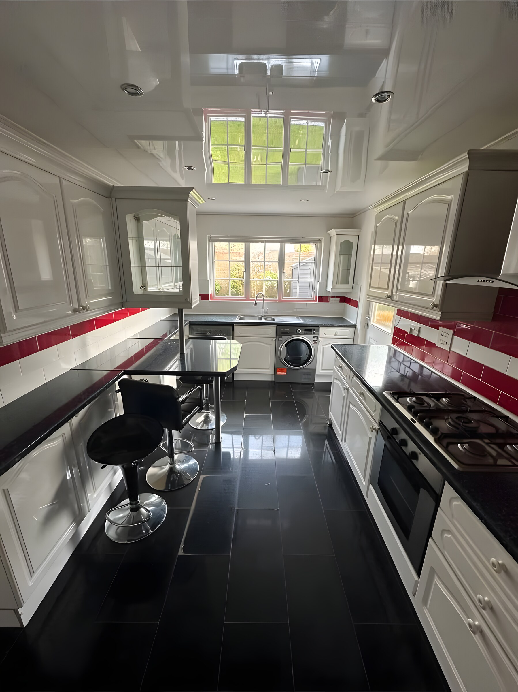 The old kitchen before the refit — red tiles and black worktops